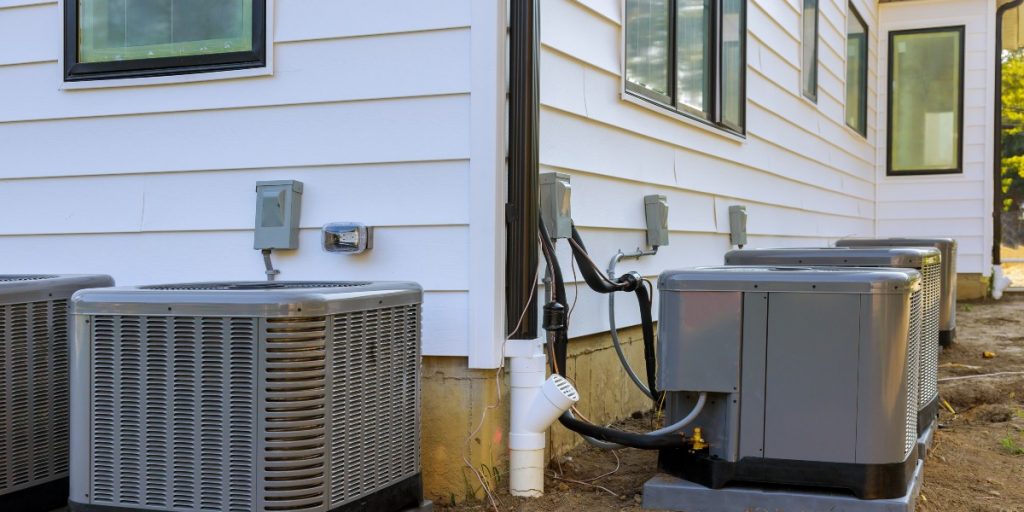 HVAC units installed outside a residential building, showcasing modern air conditioning systems and energy-efficient technology relevant to current HVAC trends.