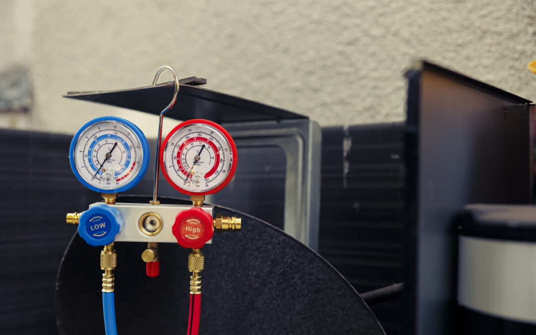 Pressure gauge set for HVAC system maintenance, featuring blue low and red high pressure gauges, illustrating essential equipment for furnace efficiency and indoor air quality improvement.