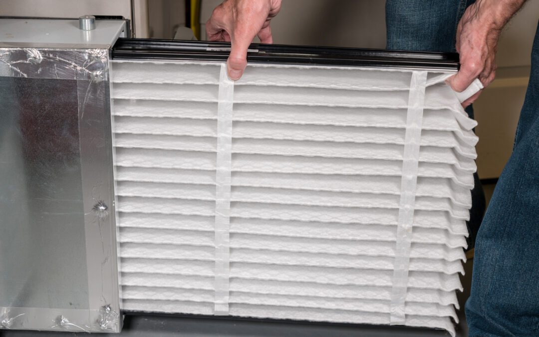 Person replacing a HVAC air filter, highlighting importance of air quality in home environments.